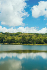 Lake with clear blue sky and white clouds, beautiful endless green mountains and waters at Jedkod Pongkonsao Natural Study in Saraburi, Thailand