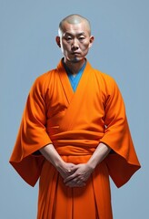 Obraz premium portrait of an Asian monk in orange robes, relaxing, isolated white background 