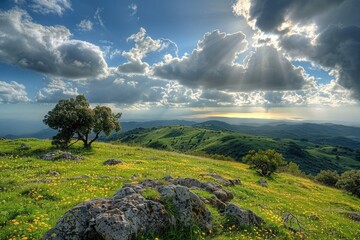Obraz premium A sunny day with sunlight shining through cloudy skies above rolling hills