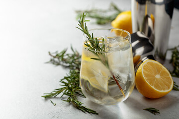 Refreshing drink with natural ice, lemon, and rosemary.