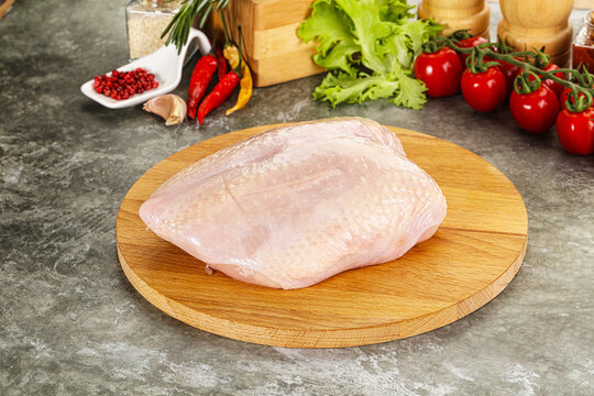 Raw chicken breast with skin