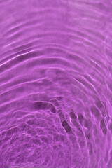 Water waves with shining swirl texture effect on a dark purple background. Abstract dynamic watery background.