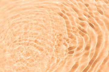 Flowing water with shining wave texture on a pastel  sunlight beige background. Abstract Water...