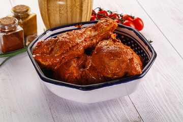 Raw turkey shoulder wing in Indian tandoori marinade