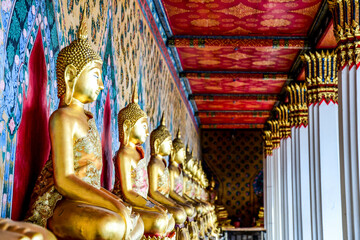 Fototapeta premium Rows of Buddha statues in a Thai temple in Bangkok