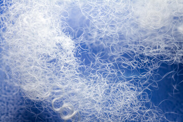 Extreme macro of polyester stable fiber on blue background