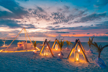 Beautiful decoration table setup for wedding ceremony on sunset beach. Romantic destination dining,...