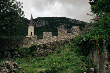 Old Bar medieval fortress. Montenegro country. A popular tourist destination- Stari Bar - ruined medieval city on Adriatic coast, Unesco World Heritage Site. A stone chapel building with a high tower.