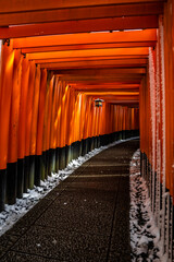 Rare Winter snow at Torii Gate Tunnel at Fushimi Inari Shrine in Kyoto Japan