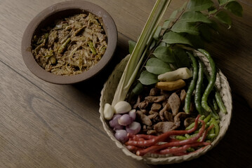 Indonesian food is placed along with its ingredients and spices in a traditional kitchen