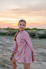 The Peak of Summer Inspiration: Teenager in a Dress, Greeting the Sunrise on the Horizon.