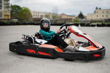 Go-Kart Racing Action With Focused Driver In Black Helmet