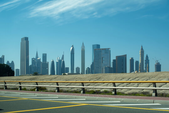 Dubai, UAE, February 22, 2024. Dubai streets. Modern buildings and skyscrapers with Burj Khalifa on the background. Empty roads.