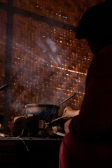 Indonesian woman cooking in traditional kitchen