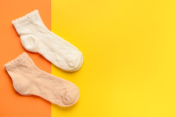 Different basic socks on color background