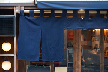 The curtain-like fabric that hangs in front of traditional Japanese restaurants and shops not only...