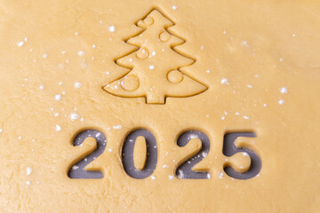 New year 2025. Cooking homemade cookies. Cutting out cookies in shape of the number 2024 and...