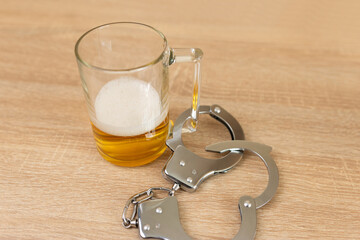 Handcuffs and a beer mug. Beer abuse concept.