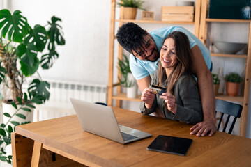 Young couple in love online shopping from home.