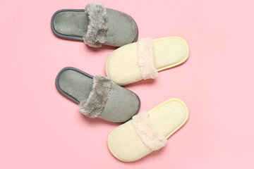 Two pairs of slippers on pink background. Top view