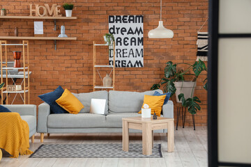 Interior of modern living room with grey sofas, view behind folding screen