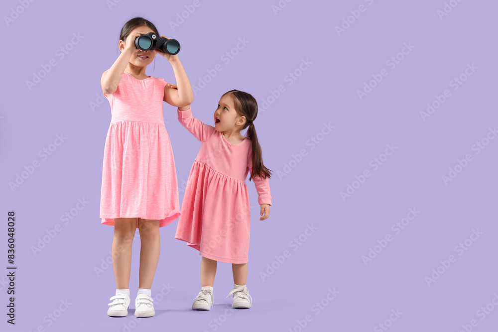 Sticker cute little asian shocked sisters with binoculars on purple background