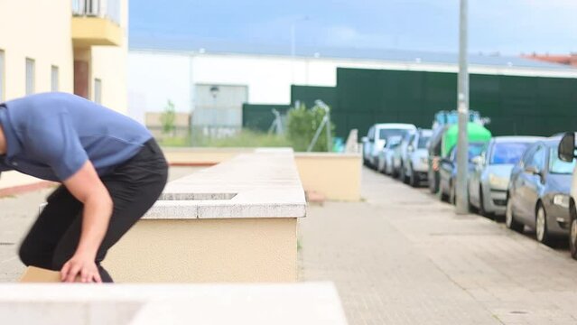 Video of package delivery man falling over dropping the packages he is carrying, dressed in uniform

