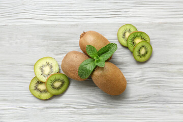 Fresh kiwi and mint on grey wooden background