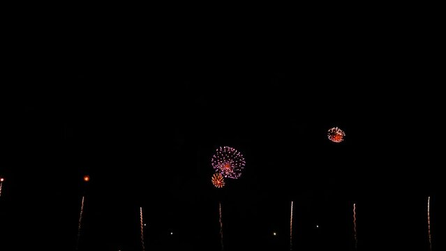 Awesome Real Huge Firework on Deep Black Background Sky on Fireworks festival. Colorful fireworks on 4th of July, Independence day in USA. High quality 4K slow motion video