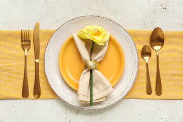 Stylish table setting with golden cutlery and beautiful flower on white background