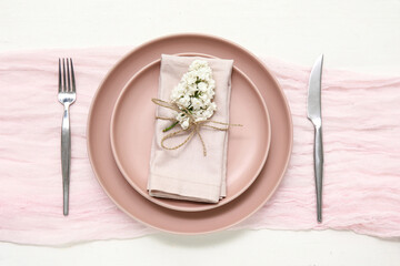 Beautiful table setting with lilac flowers on white wooden background