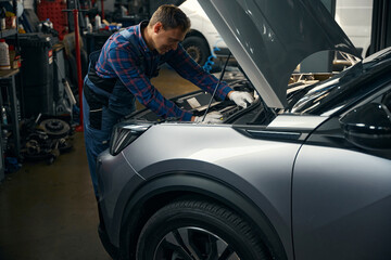 Man repairing machine in the car service center