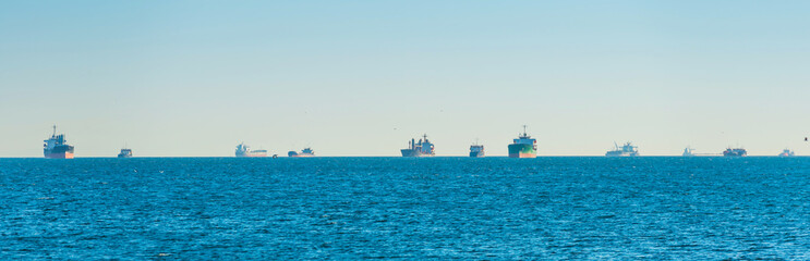 Many transport ships on blue sea, tanker cargo ships panorama