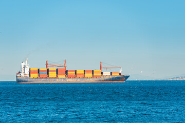 Container ship, cargo ship with many containers entering harbor port