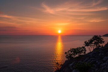 Obraz premium Beautiful sunset on Andaman sea at Windmill View Point near Laem Promthep Cape, Phuket, Thailand
