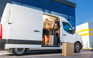 Delivery Worker Loading Boxes Into Van