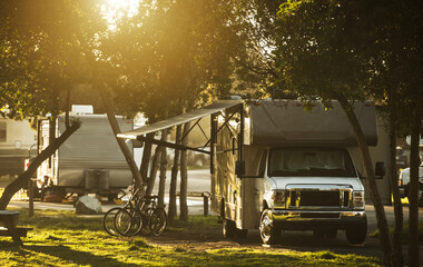 Motorhome Parked Under Trees at Sunset
