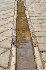 Concrete tile gutter for water drainage, stream, water drainage in the city