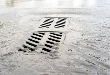 Sewage on city roads, water drainage in heavy rain, flooding.