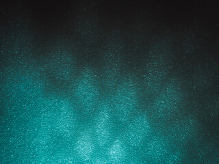 Light reflects blue shadows on a foam board in the dark for a minimalist abstract background. 
