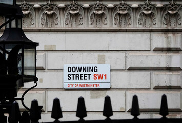 Downing Street road name sign on the wall of government building in the City of Westminster, London, UK. 