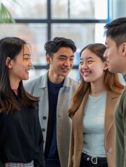 Obraz premium four young people smiling and talking together 