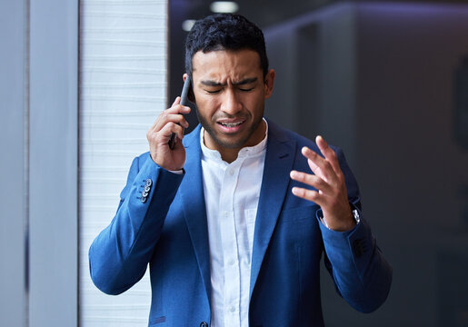 Phone call, frustrated and businessman by window for communication, anxiety and stress in office. Male executive, smartphone and upset in conversation for disappointed, difficult client and company