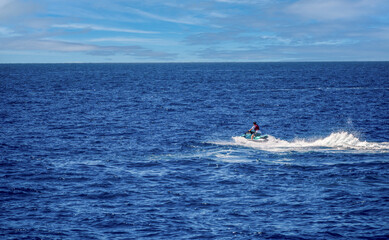 Obraz premium Jet ski in the coastal side of gran canaria puerto against blue sky in Spain, Atlantic ocean