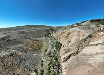 panoramic landscape with unusual red mountains with a Martian view filmed from a drone in Altai in May