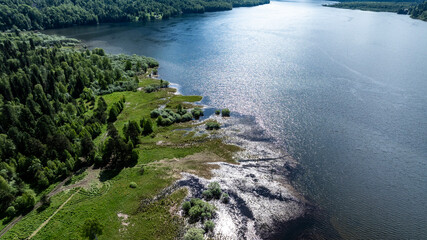 beautiful landscape with mountains and Lake Teletskoye against a background of blue sky from a drone in May