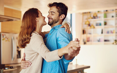 Happy couple, dancing and together in kitchen for wellness, happiness for anniversary or date. Man,...