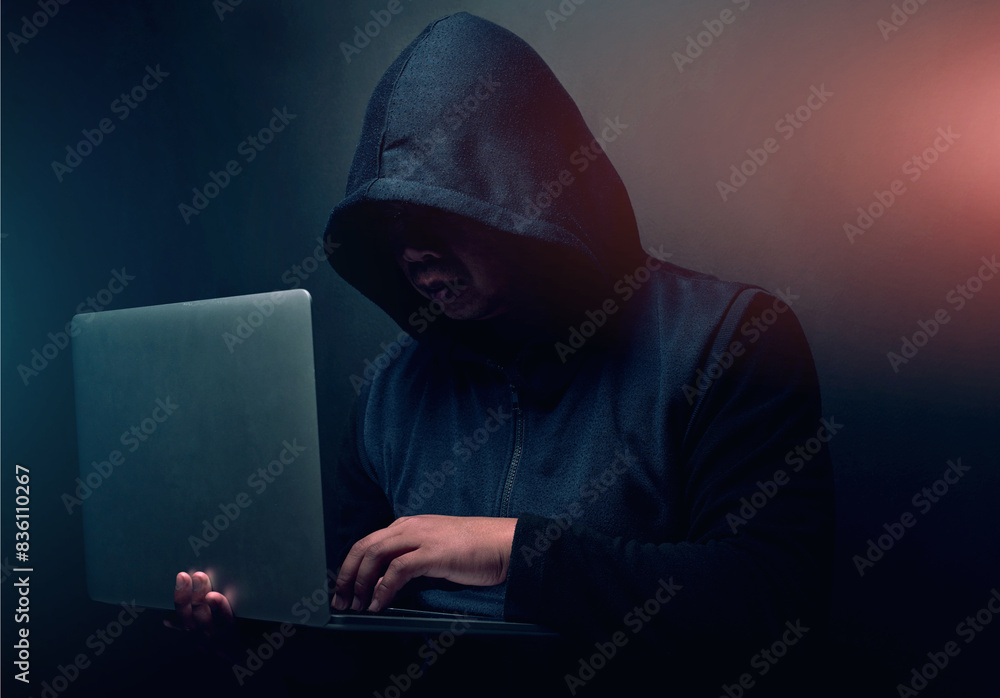 Poster online, hacker and man with laptop in studio for cyber attack, ransomware and scam on database. cybe