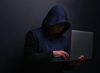 Network, hacker and man with laptop in studio for cybersecurity, malware and scam on database....