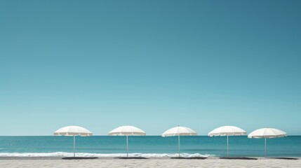 Fototapeta premium five white beach umbrellas on sandy shore by the sea